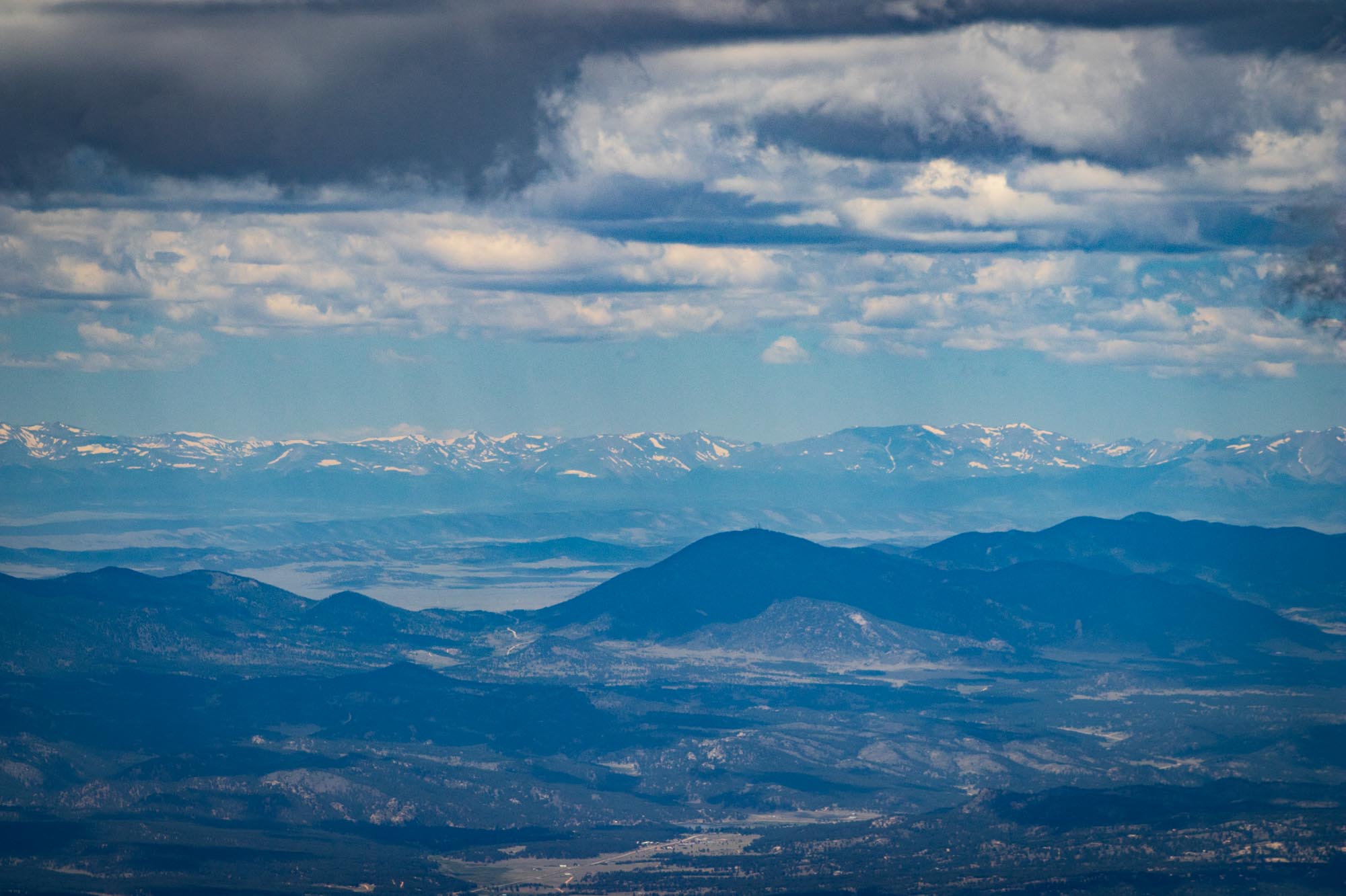 view of mountains in the distance from the top of another mountain